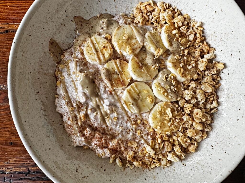 bowl of banana cinnamon overnight oats with tahini and granola