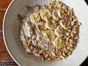 bowl of banana cinnamon overnight oats with tahini and granola