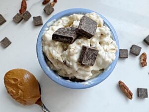 cup of lactation overnight oats with chocolate chips peanut butter and pecans